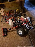Wide view of lot showing wash brush, cords, white bottle, and some accessories