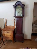 Full front view of tall case clock showing overall size, shape, and finish.