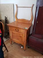 Front view showing drawer, cabinet door, removable harp and casters