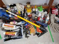 Overview of all painting supplies including rollers, spray cans, brushes, paint trays, and various tools and materials.