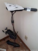 Photo showing Duramaxx Drifter I trolling motor assembled, featuring black shaft, propeller, and control handle with wiring attached, positioned on floor.