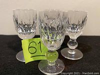 Three Waterford Maureen pattern shot glasses arranged with one in front and two in the back, showing overall design and shape.