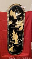 Full view of the Chinese wall hanging art with two figures, mountains, and clouds painted in gold and light colors on black lacquer