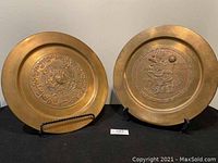 Photo showing both copper plates side by side on display stands, highlighting their size and overall condition.