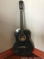 Front view of full guitar against wall