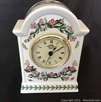 Front view of Portmeirion Botanic Garden mantel clock showing clock face with Roman numerals and floral decoration.