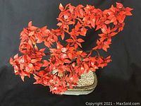 Front view of the decorative Oriental tree showing the vibrant red leaves and stone-like rectangular base with speckled texture.