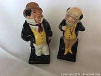 Both Royal Doulton figurines showing front and side views, capturing details of characters and condition.