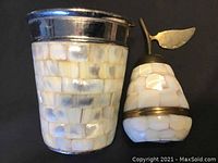 Pear shaped box and cup side by side showing their respective sizes and mother of pearl inlays with metal accents