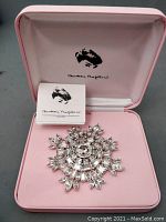 Rhinestone brooch in pink box with branded interior and paper insert