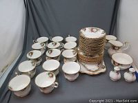Wide shot of all pieces including cups, saucers, platters and accessories