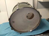 Front view showing Remo drum head with hole and worn marks.