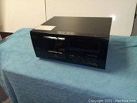 Front and side view of Pioneer PD-F505 CD player on blue cloth showing overall condition and labeling.