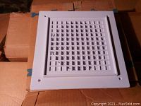 Front view of a white square Soundolier speaker baffle with grille pattern.