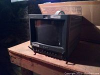 Front angled view of Sony PVM-8042Q monitor showing screen and front control panel including CAMER 1 label