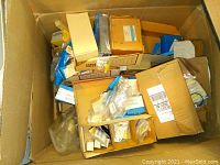 Open cardboard box with multiple smaller boxes inside containing new old stock electronic components.