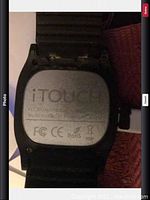 Photo of back of iTouch smart watch showing model IW04, certifications and branding.