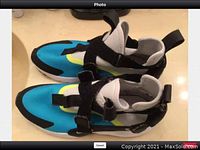 Nike sneakers top-side view showing blue, black, white and yellow colors and strap closures.