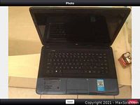 HP 2000 notebook computer opened showing keyboard, touchpad, and screen off.