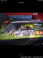 Photo of product packaging showing tent set up, brand, and features.