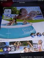 Photo of Intex Easy Set pool box showing brand, product name, and image of pool with happy children.