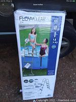 Photo of Flowclear pool ladder box showing front image with children using ladder and brand name