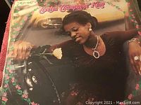 Evelyn 'Champagne' King vintage LP cover showing artist leaning on a car with pink floral border