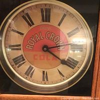Close-up of clock face showing dial artwork and hands