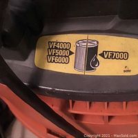 Close-up image of the wet vacuum showing a label with filter model numbers VF4000, VF5000, VF6000, VF7000 and image of a filter with water drop on it.
