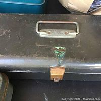 Dark metal tackle box with worn Moyn Country Falls City decal and metal handle