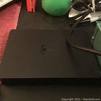 Dell wireless keyboard closed and shown on flat surface.