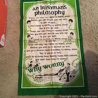 Full view of green and white decorative towel with text 'An Irishman's Philosophy' and illustration.