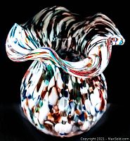Front view of vintage hand-blown art glass vase with spatter pattern and ruffled edges.