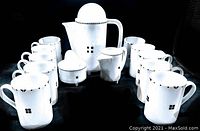 Group shot of entire 13-piece set: coffee pot, creamer, sugar bowl and ten mugs