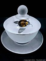 Frosted art glass honey bowl with lid featuring amber art glass accent, showing the bowl and saucer from above angle.