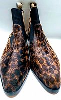 Front view showing pointed toe and leopard-print hair-on calfskin upper