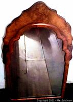 Full front view of mirror showing frame and mirror surface