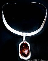 Front view of the vintage sterling silver choker necklace with attached oval amber pendant, showing overall design and finish.