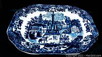 Blue and white ironstone serving platter with European cityscape scene and floral border.