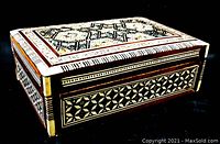 Side view showing geometric inlay patterns and wood border details of the trinket box.