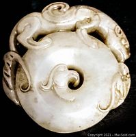 Top view of carved jade disc showing dragon and scroll details