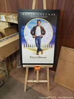 Full view of framed poster on easel