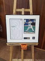 Framed signed scorecard on left with photo on right, showing overall layout of memorabilia.