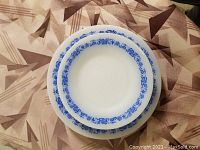 Overview of stacked plates showing different sizes of the same design.