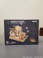 Front view of box showing constructed marble climber model and product name.