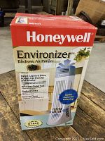 Box of Honeywell Environizer electronic air purifier with feature highlights and image of product on front.