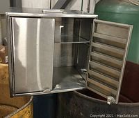 Image showing the cabinet with both doors open revealing the adjustable interior metal shelf and latch closures on doors.