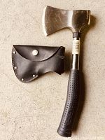 Mastercraft axe with leather protective casing showing axe head, handle, and sheath on concrete background