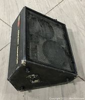 Full view of vintage Sunn Concert Monitor speaker cabinet showing the front metal grille, two large speaker drivers behind grille, and black tolex covering with metal corner protectors.