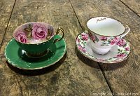 Both teacup and saucer sets side by side on wood surface